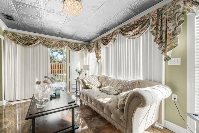 living area with an ornate ceiling and baseboards