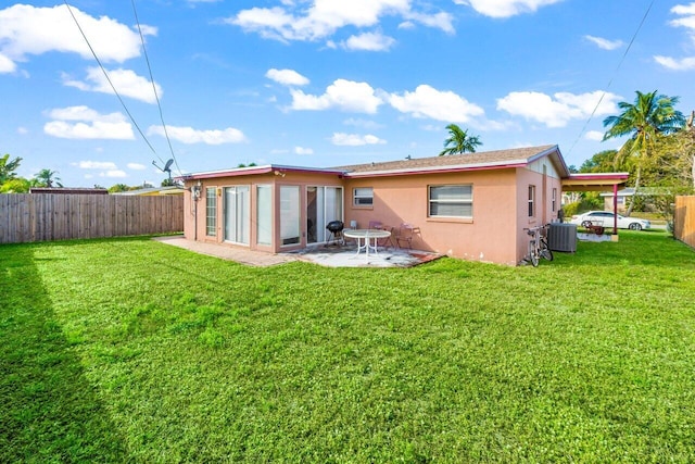 back of property featuring a yard, a patio area, cooling unit, and stucco siding