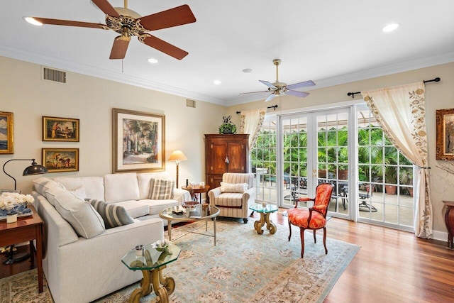 living room featuring crown molding, ceiling fan, light hardwood / wood-style floors, and french doors