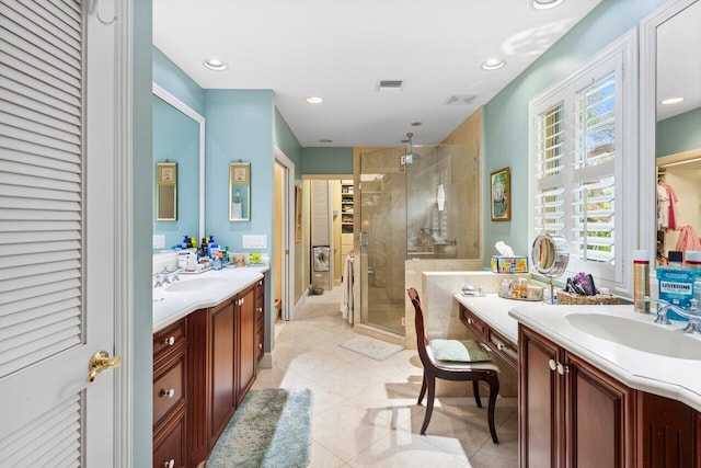 bathroom featuring vanity, tile patterned flooring, and a shower with door