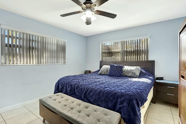 tiled bedroom featuring ceiling fan