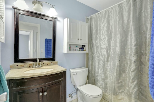 bathroom featuring vanity, curtained shower, and toilet