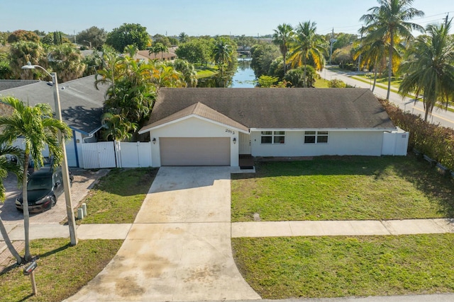 view of front of property with a garage and a front lawn