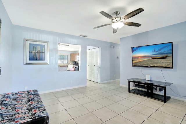 tiled living room featuring ceiling fan