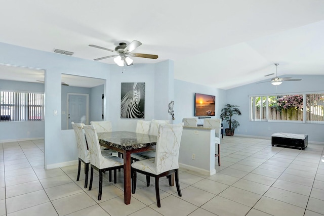 tiled dining room with lofted ceiling and ceiling fan