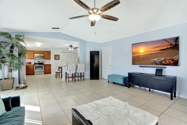 tiled living room with ceiling fan and lofted ceiling