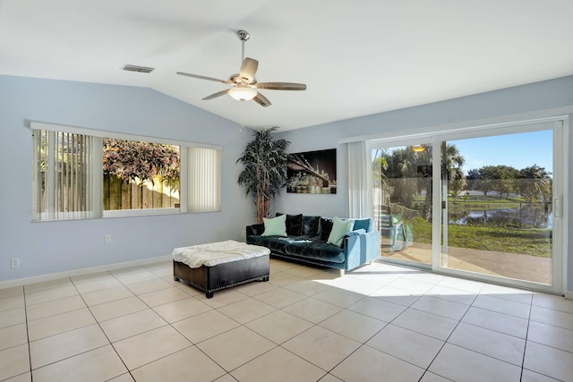 living room with lofted ceiling, light tile patterned floors, and ceiling fan