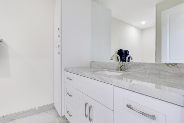 bathroom with marble finish floor, vanity, and recessed lighting