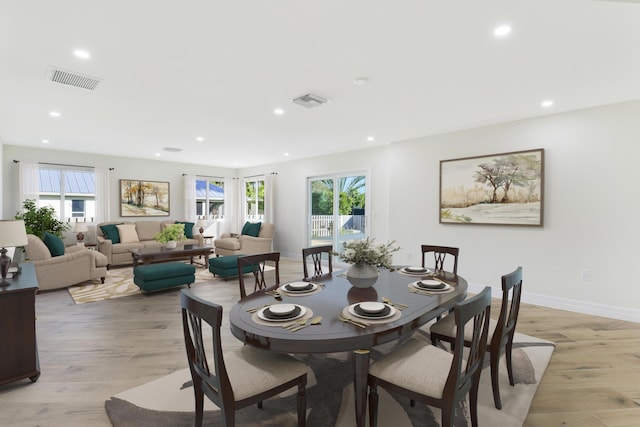 dining room featuring light wood-style floors, baseboards, visible vents, and recessed lighting