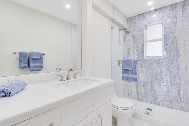 bathroom featuring recessed lighting, a walk in shower, toilet, and vanity
