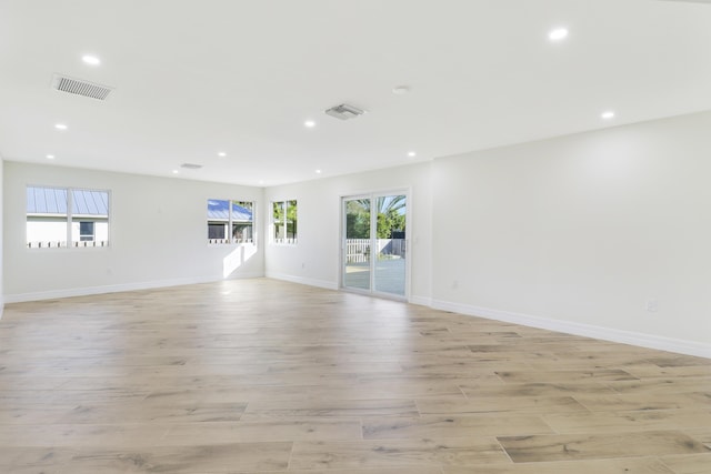 unfurnished living room with visible vents, light wood-type flooring, recessed lighting, and baseboards