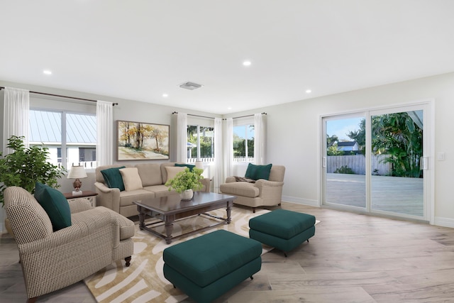 living room featuring recessed lighting, light wood-type flooring, visible vents, and a healthy amount of sunlight