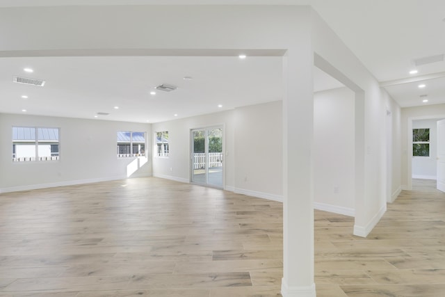 unfurnished living room with visible vents, recessed lighting, light wood-style flooring, and baseboards