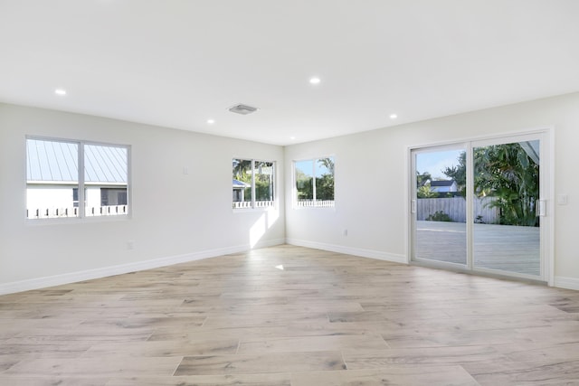 spare room featuring baseboards, recessed lighting, visible vents, and light wood-style floors