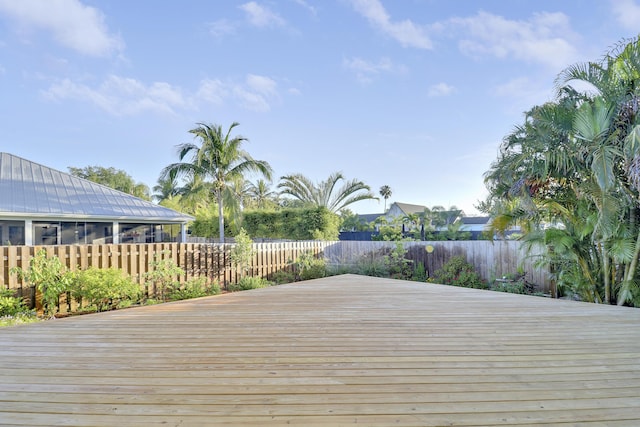 wooden terrace featuring a fenced backyard