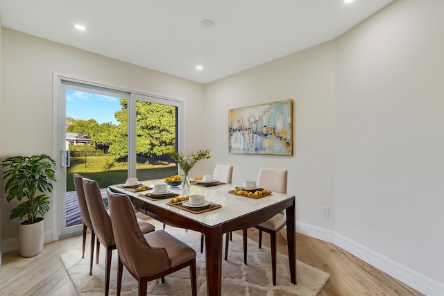 dining space with baseboards, recessed lighting, and light wood-style floors