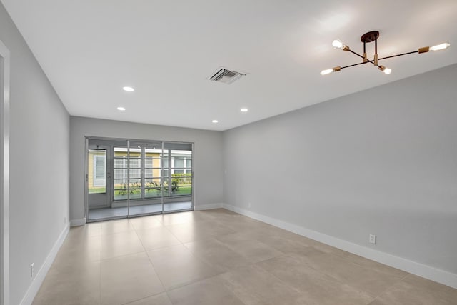 empty room featuring an inviting chandelier