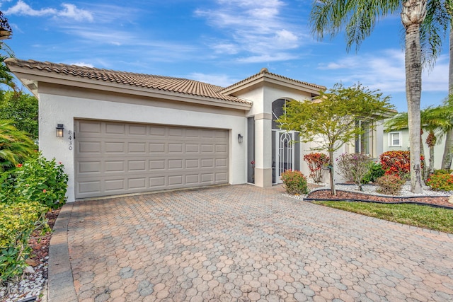 mediterranean / spanish-style home with a garage