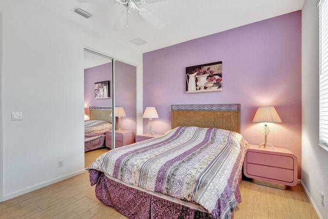 bedroom with light hardwood / wood-style floors, a closet, and ceiling fan