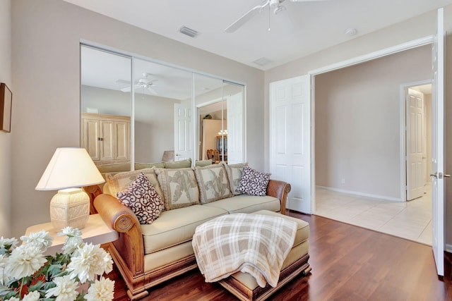 living room featuring hardwood / wood-style flooring and ceiling fan