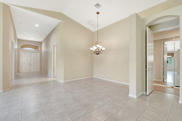 8430 Marsala Way, Boynton Beach, FL 33472 - empty room with light tile patterned flooring, a chandelier, arched walkways, lofted ceiling, and baseboards