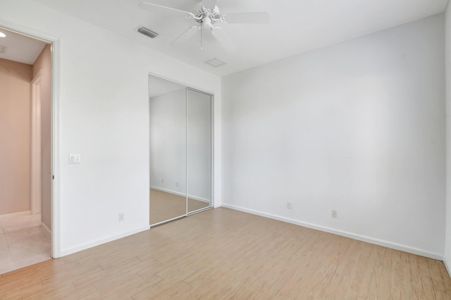 8430 Marsala Way, Boynton Beach, FL 33472 - unfurnished bedroom with wood finished floors, baseboards, a closet, and a ceiling fan
