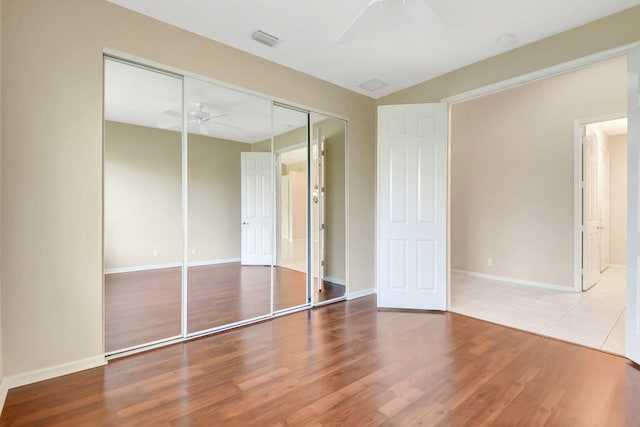 8430 Marsala Way, Boynton Beach, FL 33472 - unfurnished bedroom with a closet, wood finished floors, baseboards, and a ceiling fan