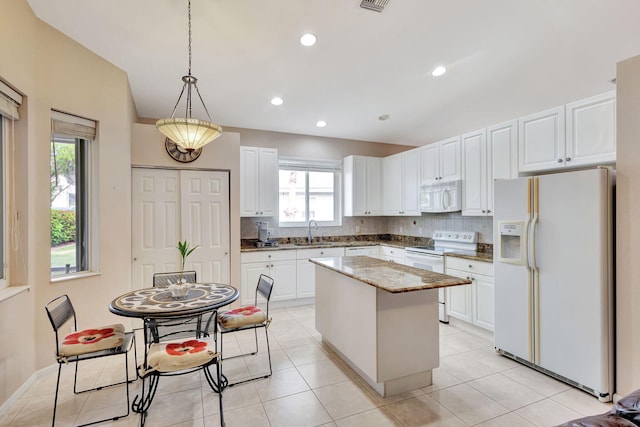 kitchen featuring white cabinetry, sink, hanging light fixtures, a center island, and white appliances