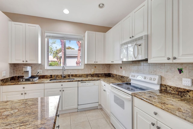 kitchen featuring white cabinetry, sink, stone countertops, and white appliances