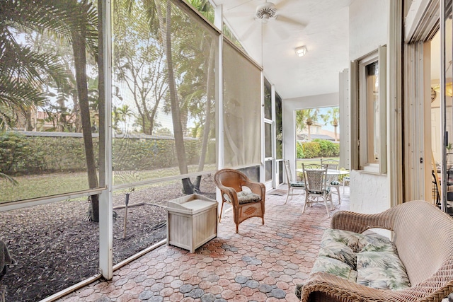 sunroom / solarium with ceiling fan and vaulted ceiling