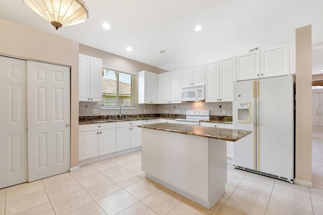 8430 Marsala Way, Boynton Beach, FL 33472 - kitchen featuring white appliances, a sink, dark stone countertops, white cabinetry, and recessed lighting