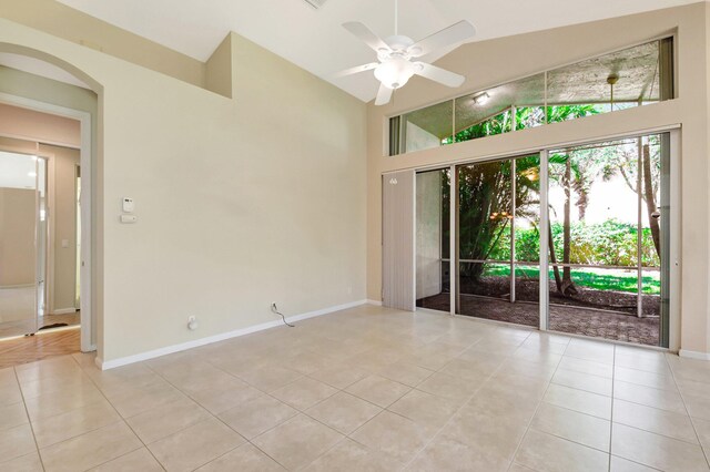 8430 Marsala Way, Boynton Beach, FL 33472 - unfurnished room featuring light tile patterned floors, a ceiling fan, high vaulted ceiling, arched walkways, and baseboards