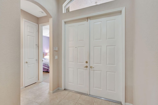 8430 Marsala Way, Boynton Beach, FL 33472 - foyer with arched walkways, light tile patterned floors, and baseboards