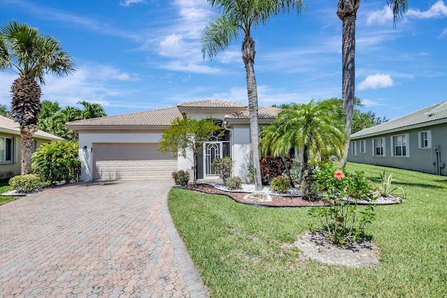 8430 Marsala Way, Boynton Beach, FL 33472 - view of front facade with a tiled roof, stucco siding, an attached garage, and decorative driveway