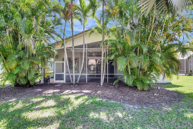 8430 Marsala Way, Boynton Beach, FL 33472 - rear view of property featuring a yard, a sunroom, and stucco siding
