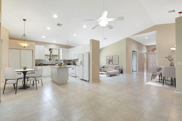 8430 Marsala Way, Boynton Beach, FL 33472 - kitchen featuring white appliances, open floor plan, a center island, vaulted ceiling, and a ceiling fan