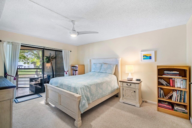 carpeted bedroom with access to exterior, a textured ceiling, and ceiling fan