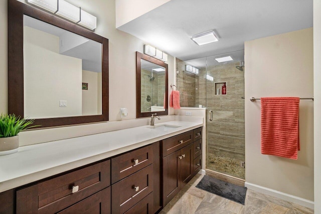 bathroom featuring vanity and a shower with door