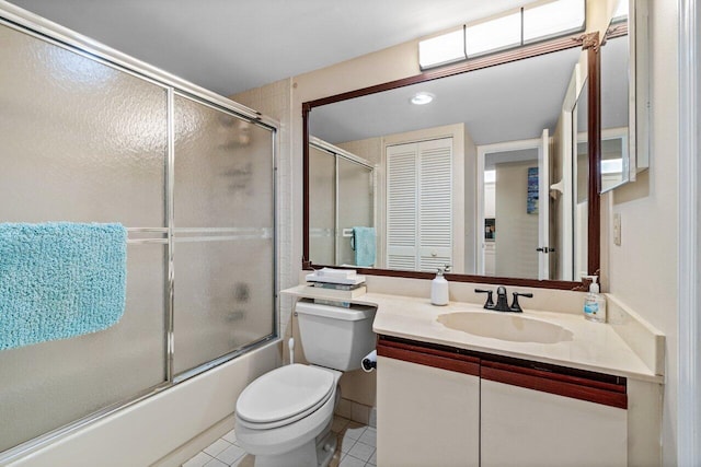 full bathroom with vanity, tile patterned floors, shower / bath combination with glass door, and toilet