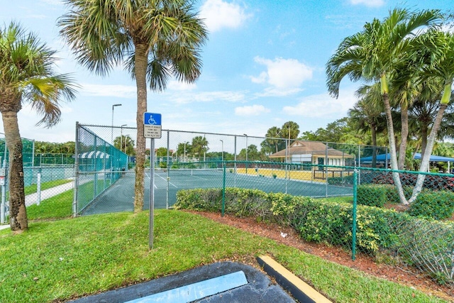 view of sport court with a lawn