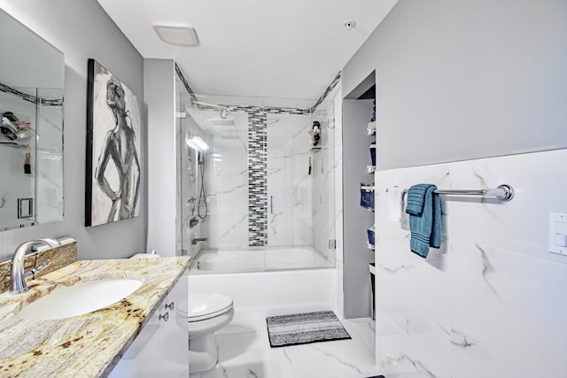 full bathroom with vanity, tiled shower / bath combo, and toilet