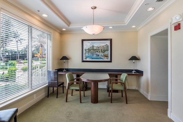 sitting room featuring light carpet, crown molding, and a raised ceiling