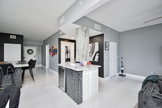 kitchen with a kitchen island and beverage cooler