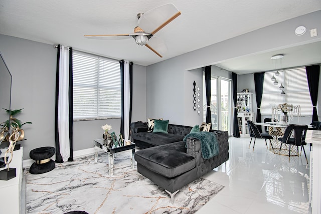 living room featuring a textured ceiling and ceiling fan