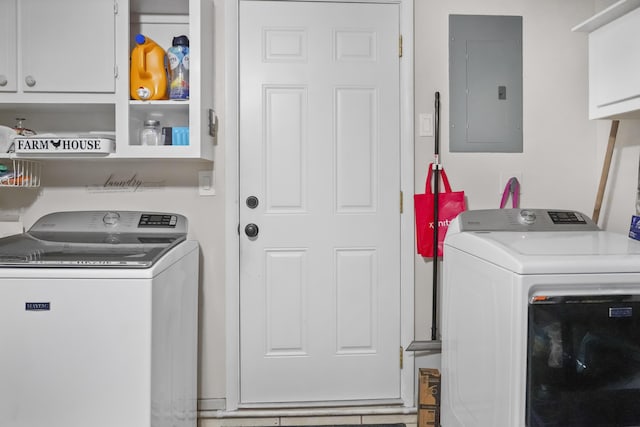 laundry area with electric panel, cabinets, and washing machine and dryer