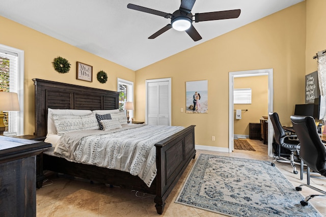 bedroom with vaulted ceiling, a closet, ceiling fan, and light tile patterned flooring