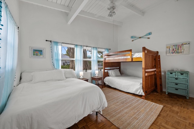 bedroom with beam ceiling, dark parquet flooring, high vaulted ceiling, and ceiling fan