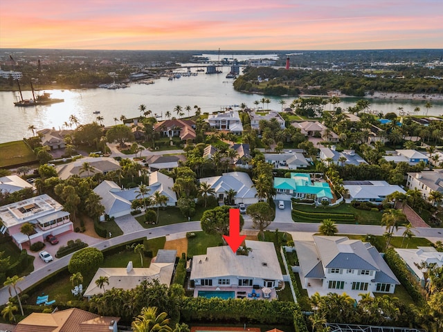 aerial view at dusk with a water view