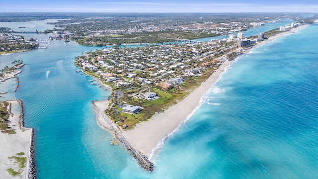 bird's eye view with a water view and a beach view