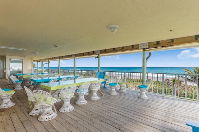 wooden terrace with a water view and a beach view